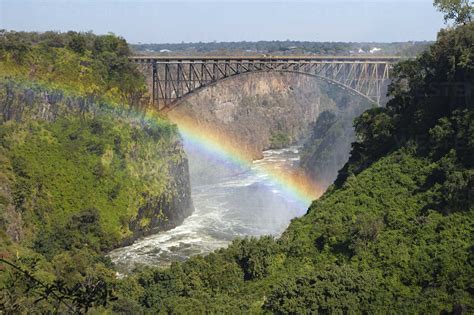 Rainbow Over The Zambezi River And Victoria Falls Bridge Zambia On