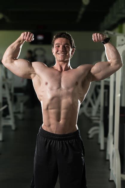 Premium Photo Bodybuilder Fitness Model Posing Double Biceps After Exercises