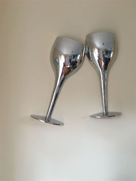 Fixed shower head and handheld shower head are 5 in. Chrome wall art, Two oversized Champagne flutes | Chrome ...