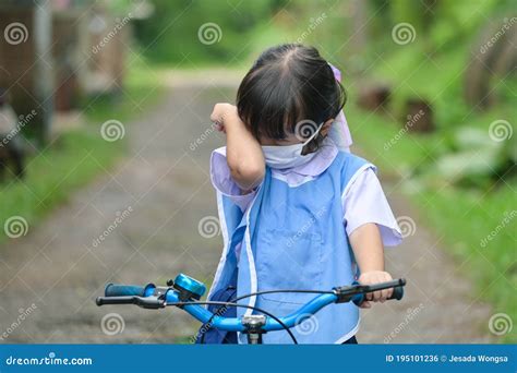 Little Girl Crying While Sitting On Bicycle At Outdoors Road Stock