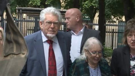 Rolf Harris Protected By Masked Security Guards As He Arrives Home