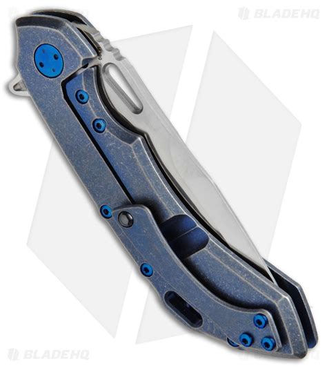 Olamic Wayfarer 247 Knife Blue SW Ti Holes Sculpted Backspacer (3.5" M390 Satin) - Blade HQ