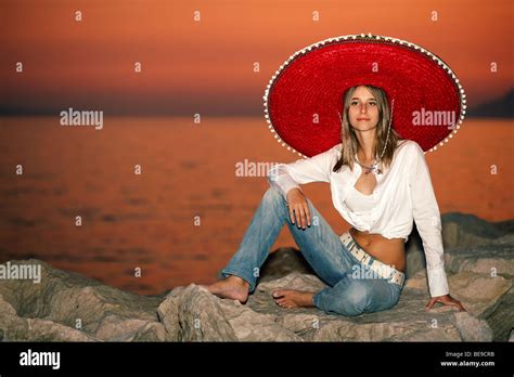 Young Girl With A Sombrero Sitting By The Sunset Stock Photo Alamy