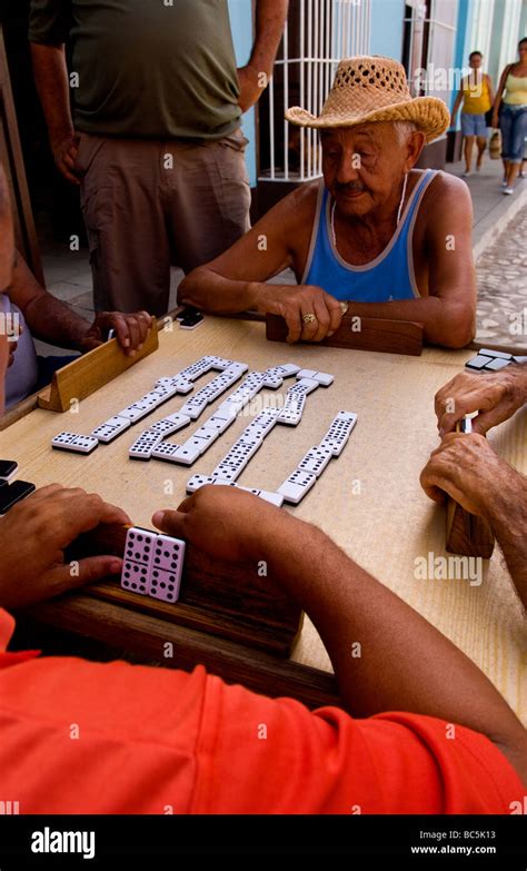 Men Playing Dominos On The Street Of Old Colonial Village Of Trinidad