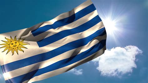 Uruguay National Flag Waving On Flagpole On Blue Sky Background Stock