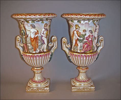 Matched Pair Of Capodimonte Porcelain Urns Cast In Relief With A