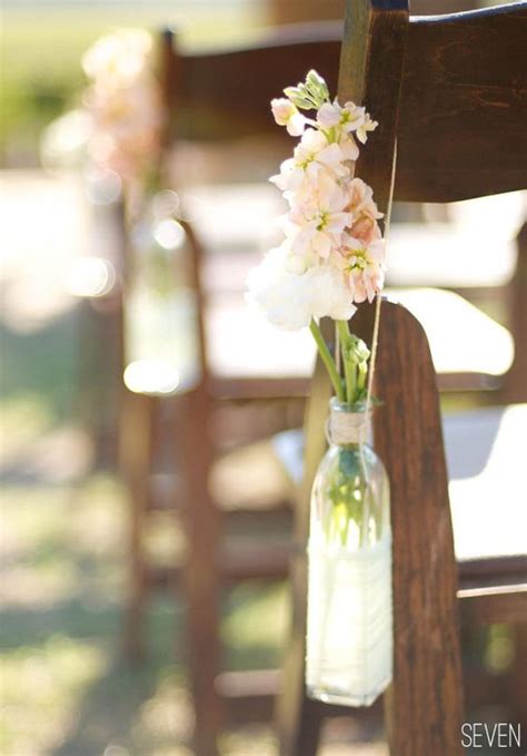 Close Up Of How To Hang Ceremony Use Flowers And Recycled Bottles
