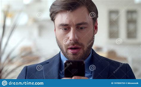 shocked business man reading sad news on cellphone amazed man looking on phone stock image