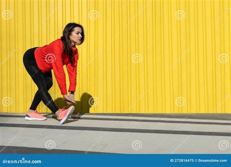 Fitness Woman Is Fitness Stretching And Exercising Outdoor In Yellow