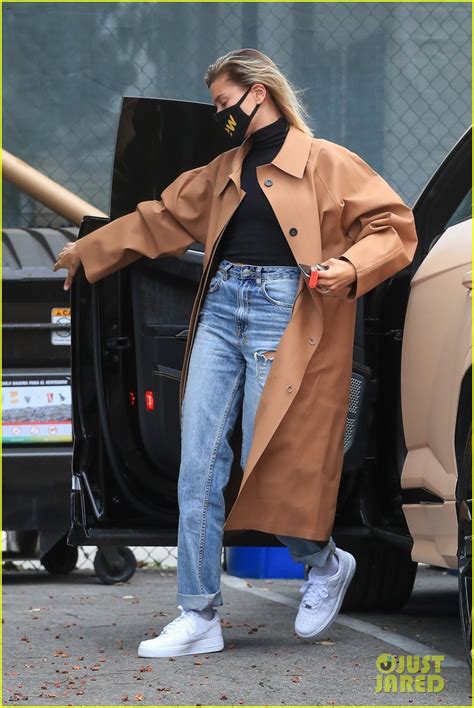 hailey bieber rocks her long trench coat on multiple errands after weekend road trip photo