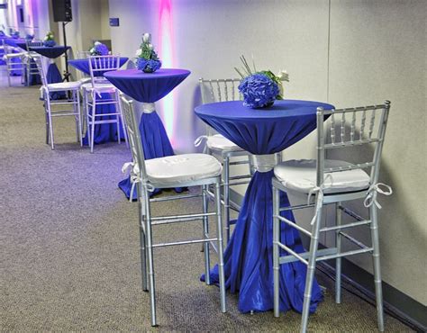 Cocktail Table Set Up With Blue And Silver Linen Hydrangea Center Piece And Tall Chivari