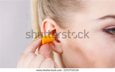 Woman Putting Ear Plugs Into Her Stock Photo 1293750136 Shutterstock