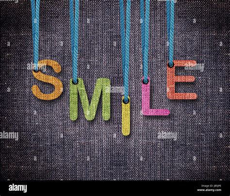 Smile Letters Hanging Strings With Blue Sackcloth Background Stock