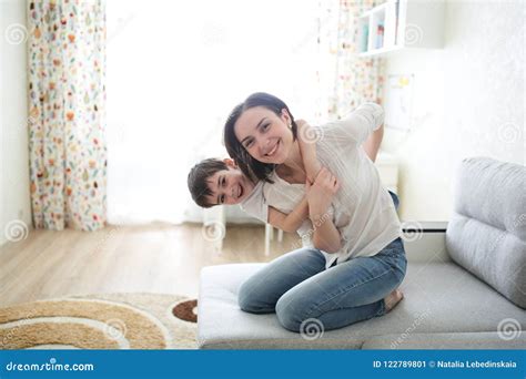 beautiful brunette mom and son hugging on couch stock image image of mood kiss 122789801