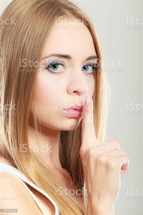 Woman Asking For Silence Finger On Lips Stock Photo Download Image