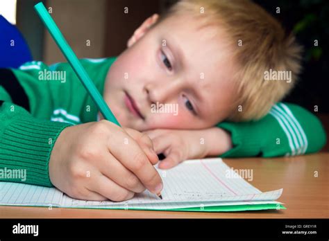 Tired boring boy doing his difficult school homework Stock Photo - Alamy