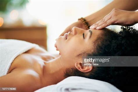 black woman massaging face photos and premium high res pictures getty images