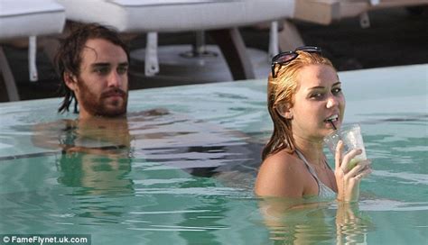 miley cyrus gets very close to male friend cheyne thomas as they frolic in the pool daily mail