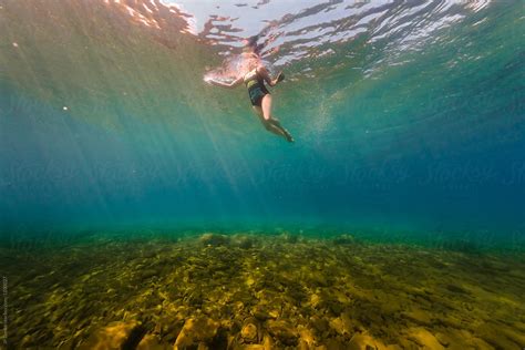 Woman Swimming Underwater In Clear Summer Lake By Stocksy Contributor