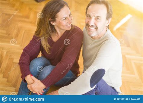 Beautiful Romantic Couple Sitting Together On The Floor At Home Stock