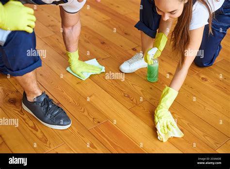 Polishing Wooden Floor With The Use Of Rags For Cleaning Wearing