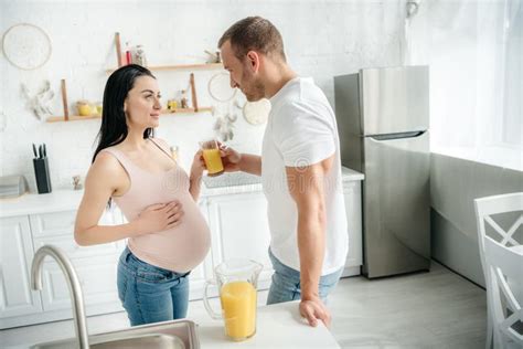 Pregnant Wife And Husband Drinking Orange Juice In Kitchen Stock Image Image Of Pour Couple