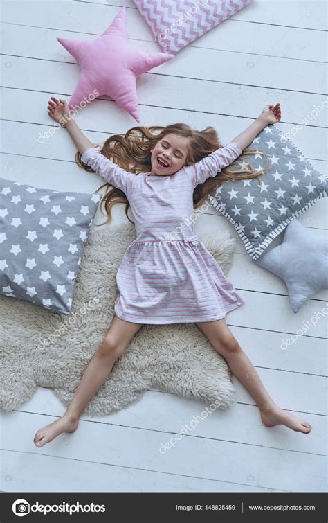 Cute Little Girl Smiling And Lying Stock Photo By ©gstockstudio 148825459