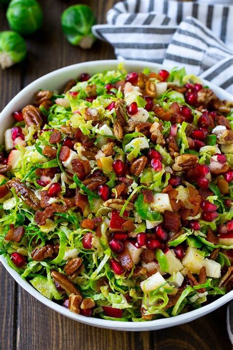 A Bowl Of Brussels Sprout Salad Made With Pomegranate Bacon And Apples