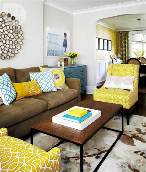 A Living Room Filled With Furniture And Yellow Pillows On Top Of Its