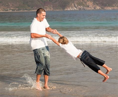 Padre E Hijo Jugando En La Playa Foto Premium