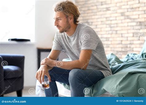 Depressed Young Man Drinking Alcohol At Home Stock Photo Image Of