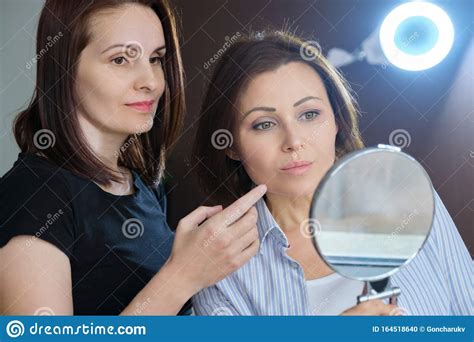 Age Woman At Consultation With Cosmetologist Female With Mirror Stock