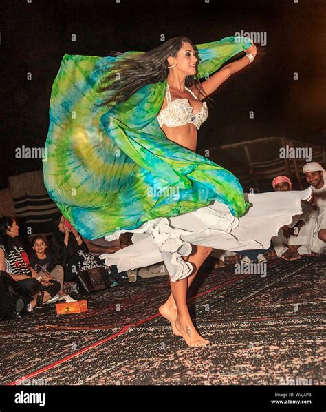 Dubai UAE Belly Dancer Twirls For Guests At Bedouin Desert Safari Camp In The Desert