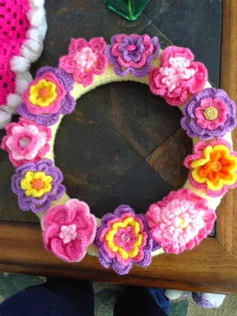 crocheted wreath cheerful flower wreath flowers from various patterns i ve collected ghirlande
