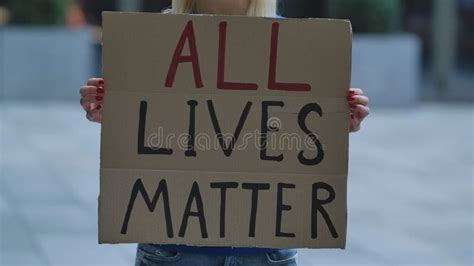 All Lives Matter On Cardboard Poster In Hands Of Female Protester