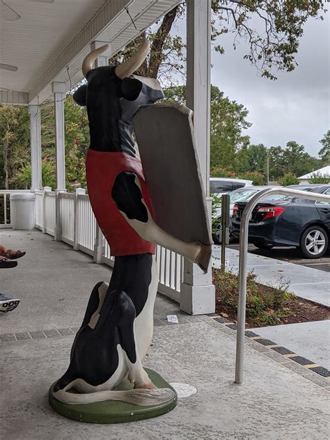 this cow statue outside a creamery r oddlyterrifying