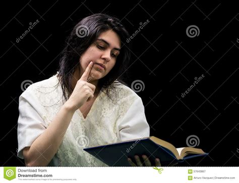 Latina Teen In White Holding A Book On Black Background
