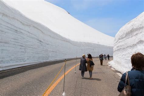 Tourists Walk Along Snow Corridor This Snow Wall Is A Part Of Kurobe