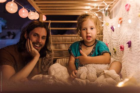 Content Father With Girl Chilling On Bed By Stocksy Contributor