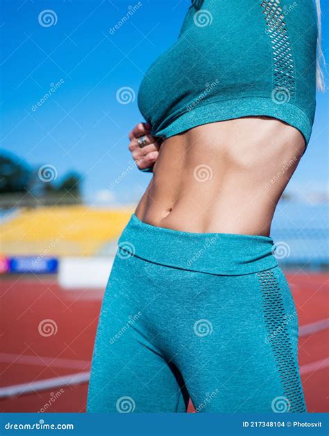 Athletic Woman In Fitness Wear Has Fit Body Belly Pose Outdoor Six