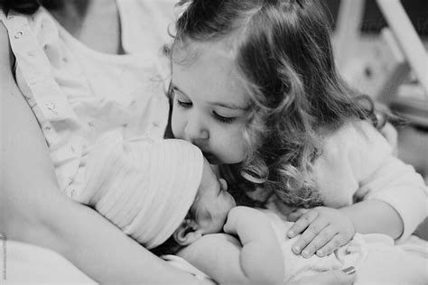 Sister Meeting Her Newborn Brother For The First Time By Stocksy