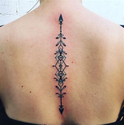 Geometric Arrow Spine Tattoo With Teal Accents 💙 Wild Tattoo Get A