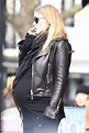 Heavily pregnant Lara Stone takes the weight off her feet as she enjoys ...