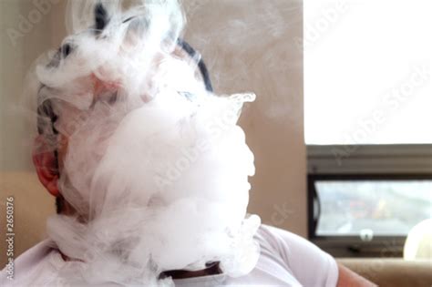 Man Blowing Smoke Completely Covering Face Stock Photo Adobe Stock