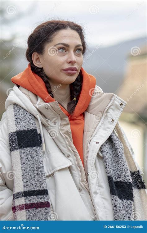 Street Portrait Of A 25 30 Year Old Woman In A White Jacket On A Bridge
