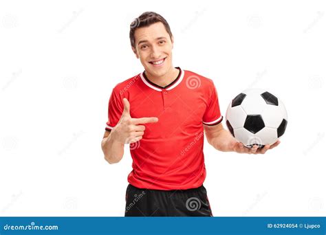 Football Player Holding A Ball And Pointing To It Stock Photo Image