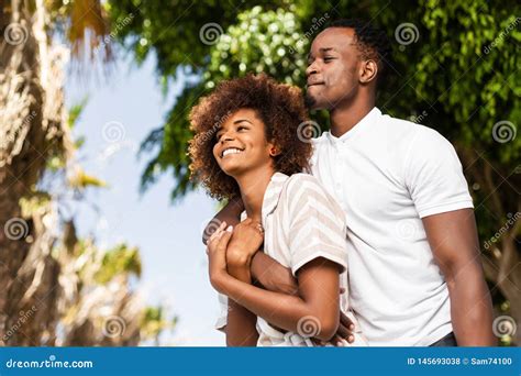 Outdoor Protrait Of African American Couple Embracing Each Other Stock