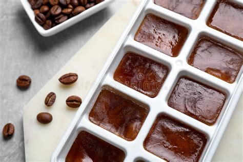 Ice Cubes In Tray And Coffee Beans On Table Closeup Stock Image
