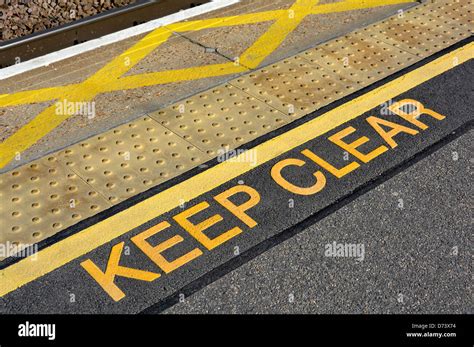 Station Platform Edge With Warning Signs Non Slip Paving And Yellow