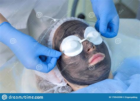 Cosmetologist Preparing Woman Patient To Carbon Laser Peeling Procedure